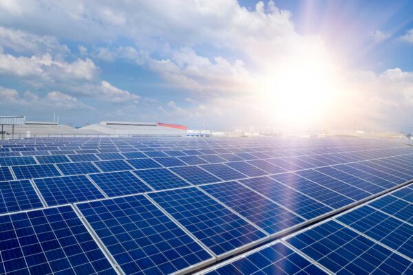 Solar panels with sun in the background